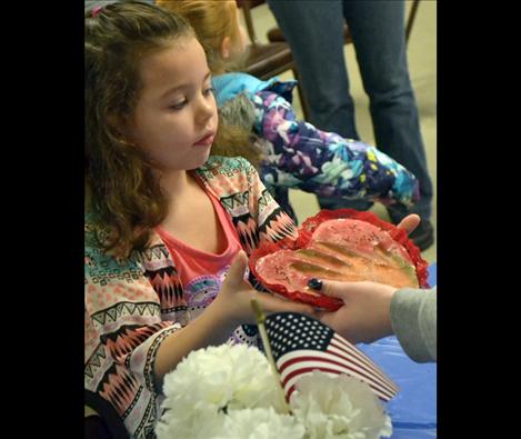 Daughter Olivia receives a handprint to hang in her room,  a valentine gift Tomy Parker in grade school made 