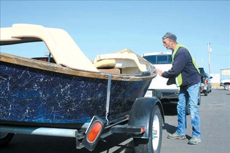 Johnny Eggebrecht inspects a boat at the Ronan checkpoint on U.S. Highway 93 before it heads to Flathead Lake.
