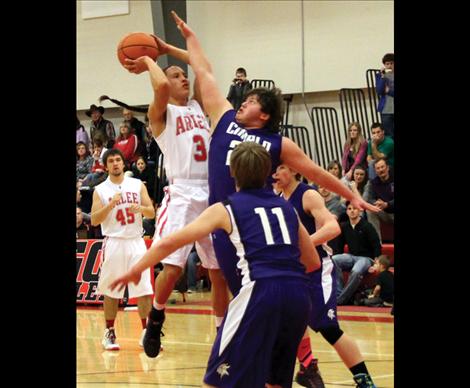 Junior Isaac Desjarlais jumps above Viking’s reach in the 14-C showdown played at home.