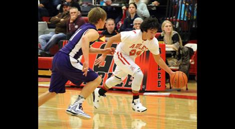 Warrior junior Justis Haynes swiftly brings the ball down court ahead of his opponents to score.