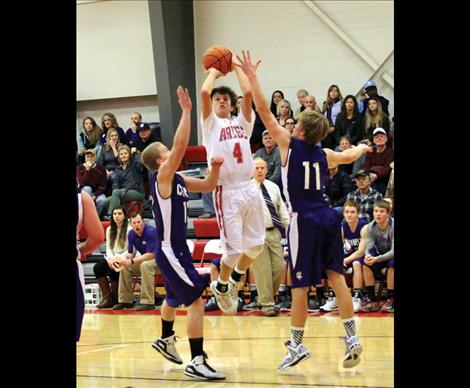 Freshman Phillip Malatare shoots above Viking hands in Thursday’s rival game.