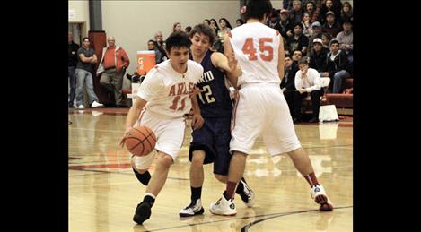 Sophomore Tyler Tanner craftily moves around Charlo defense in Thursday’s rival game. Tanner has been a point producing machine for the Warriors.