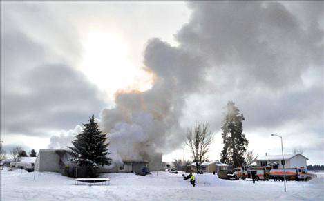 Firefighters fight a blaze Jan. 14 at 34132 Loolee Drive that left two families homeless.