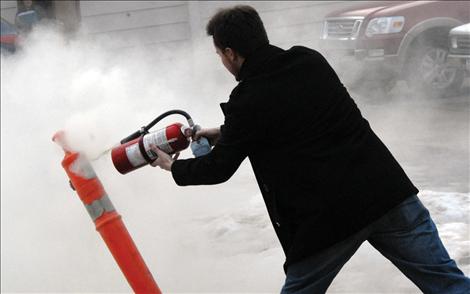 Kyle Newman sprays the “intruder” prior to bashing it. 