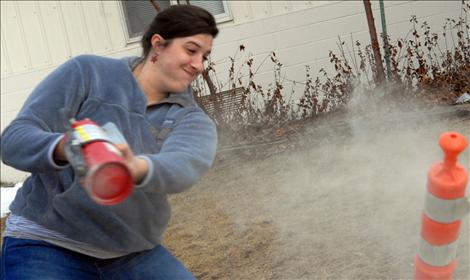 Arlee English teacher Ashley Gaumer prepares to smash an “intruder” at the LCSO training for Arlee teachers.