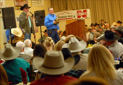 A sea of hats surrounds the stage as auctioneer Blake Nuffer sells items to benefit the WMSA.