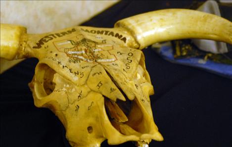 A horned skull painted with brands makes a one-of-a-kind decoration for a ranch house.