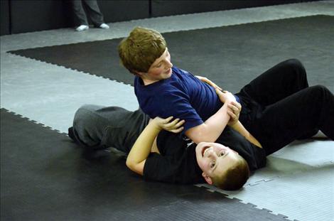 Karen Peterson photo Christian Smith, 12, and Gabe Moxness, 13, practice their skills on the new mats.