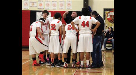 Eagles Coach Jami Hanson discusses a plan of attack during timeout at Friday’s game against St. Regis. The Eagles have been on fire and hope to stay hot through postseason.