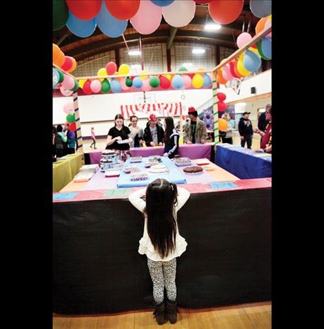Gracie Hammer eyes the cakes as she waits for the cakewalk to