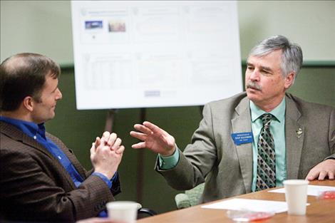 Representative Dan Salomon, right, discusses healthcare issues with Steve Todd.