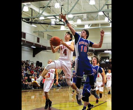 Warrior Phillip Malatare drives to the basket during District play, and scored double digits in two games last weekend at Divisionals.