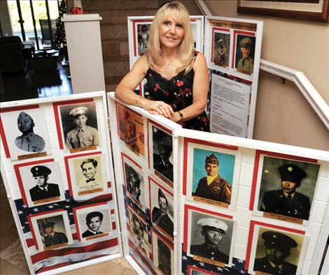 Janna Hoehn displays photos of 42 Former Maui residents whose names are etched on the Vietnam Veterans Memorial Wall.