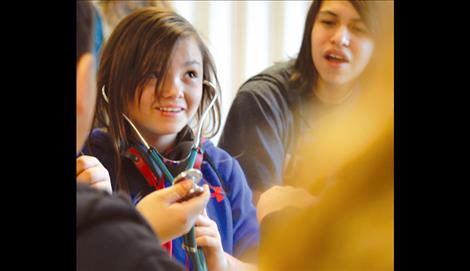 Leilani Butler, student at C.S. Porter Middle School, explores career options Friday with help from students majoring in education at Salish Kootenai College.