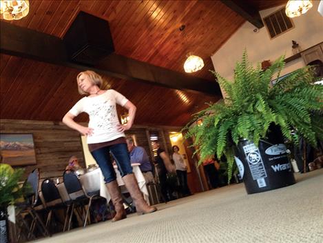 Denise Zemke models the latest fashion from Murdoch’s Ranch and Home Supply during the Color My World fashion show held at Ninepipes Lodge on Saturday. Organized by the Friends of Ronan Fairgrounds and Murchoch’s, the fashion show luncheon was a fundraiser for the Lake County Fairgrounds in Ronan.  