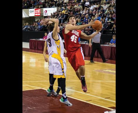 Warrior Bradley Brazill works around Northern Cheyenne defense as the Warriors pick up the win in the opening contest of the State tourney.