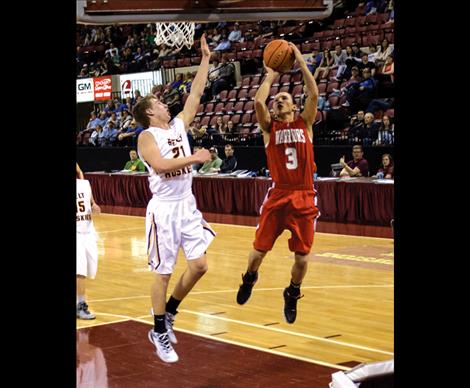 Warrior Isaac Desjarlais takes a shot at the net in the close game against Belt, the undefeated State champs.