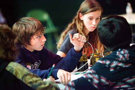 Trance Bird and other St. Ignatius students team up at the buzzer to answer trivia questions in the Academic Bowl. 