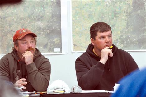 Flathead Joint Board of Control Commissioners Paul Guenzler and Trent Coleman listen to Chairman Jerry Laskody explain the funding efforts for an irrigation study