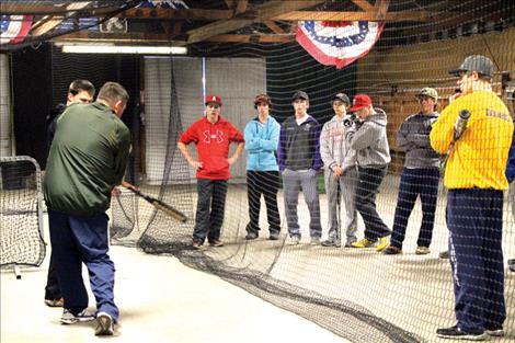 Coach Jami Hanson and Assistant Coach John Rausch instruct their young team on hitting mechanics as the Mariners prepare to kick off a new season.