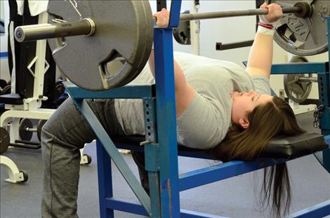 Rachelle Meidinger lifts a couple hundred pounds as she trains at the Joe McDonald Fitness Center.