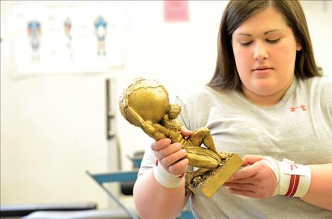 Meidinger holds the trophy she earned at the 2015 World Association of Bench Pressers and Dead Lifters championship.