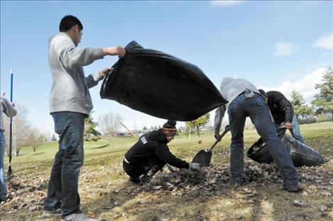 Members of the Ronan Golf team clean up leaves from the Mission Mountain Golf Club. 