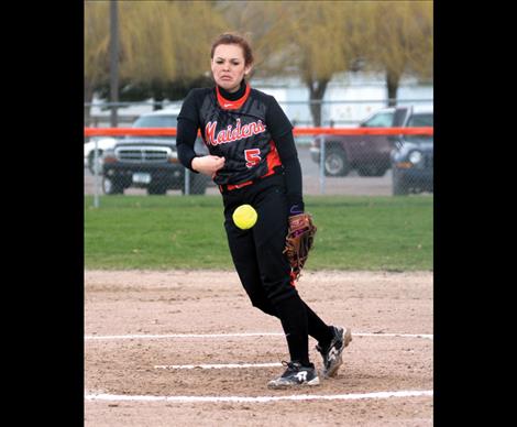 Junior Carston Rhine fires a pitch from the circle in Tuesday’s opener.