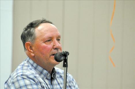 Poet Barry Baker reads cowboy poems to the crowd.