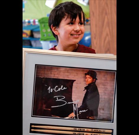 Cole shares the signed photo and drumsticks pop singer Bruno Mars gave Cole when he met Mars, thanks to Montana Make A Wish.