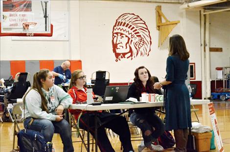 Julie Kieckbusch Jones of the American Red Cross explains the details of the blood drive to some of the National Honor Society students organizing the event