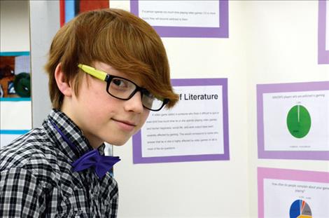 Jonas Paul, 11, displays his research about the effects of video games on the brain.