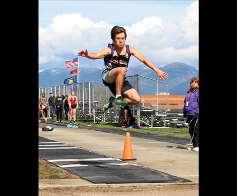 Pirate Danny DiGiallonardo launches over the sand in the long jump event where he placed third. DiGiallonardo placed first in the 300 hurdles.