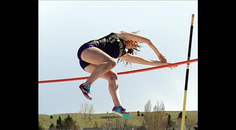 Lady Pirate Lydia Bowman easily clears the bar as she vaults over in the pole vault event. Bowman placed first in pole vault at Thursday’s home-hosted Triangular meet after battling a stormy spring day that left athletes bundling up between events