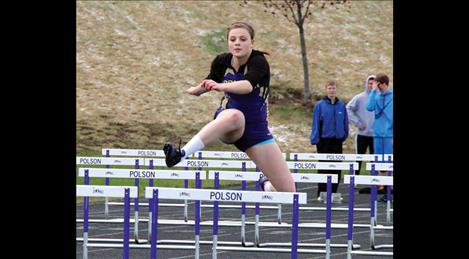 Lady Pirate Madison Wheeler leaps over a hurdle, placing third in the 300m race.