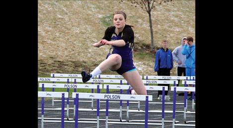 Lady Pirate Madison Wheeler leaps over a hurdle, placing third in the 300m race.