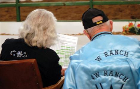 Jean and Bob Harshberger check the Valley View Charolais Ranch bull sale catalog as they bid on bulls at the sale. 