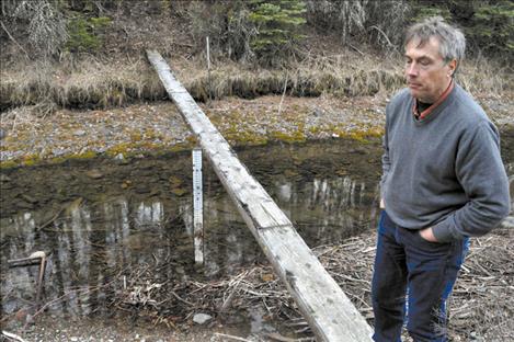 Tribal hydrologist Seth Makepeace stands near part of a water measurement system in Pablo