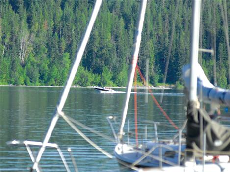 A boat skims over Flathead Lake in clean water, which is what the Flathead Lakers promote and work to protect.