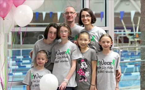 The Crist family shows off their new haircuts with Lily, whose Chinese name is Aixiao. The family — Elissa, Tiana, Malech, Claire and parents Sally and Chad Crist — wears T-shirts created to support Lily’s bone marrow transplant journey. 