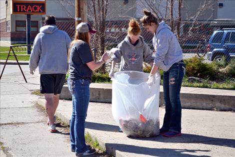 Members of Ronan High School’s spring sports teams — including, from left, Ronan High School track and field throwing coach Rod Harris, and athletes Aspen Jore, Alex Dennis and Ashley Peterson — commemorated National Volunteer Week by fanning out and cleaning up garbage around town last week. Ronan Booster Club Secretary Debbie Garcia said she thought it was a good idea for the kids to support the local community, because of the support the town, its people and businesses give to the sports teams. Two truckfulls of waste were collected.