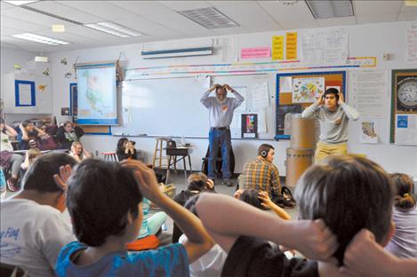 Poet Victor Charlo and Salish Kootenai College instructor Alex Alviar help Pablo Elementary School students get their creative juices flowing. 