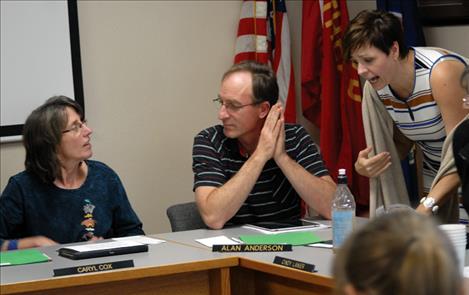 Polson School Board Trustees Caryl Cox, Alan Anderson and Caroline McDonald discuss issues during a break.