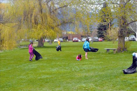 Members of the Ronan Boys and Girls Club clean Bockman Park as a community service. 