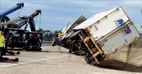 Draggin’ Wagon wreckers pull a semi truck and trailer back onto its wheels after a wreck near Blue Bay.