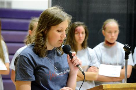 Madison Savage, 16, speaks to students during the Ghost Out event at Charlo High School.