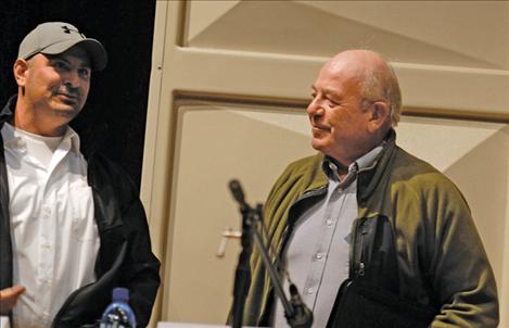 Candidates Daryl Kerr, left, and Dennis DeVries compare notes after the forum. About 50 community members attended.