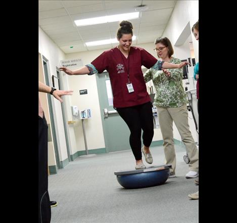 Mariah Durglo of St. Ignatius explores the equipment in the physical therapy department.