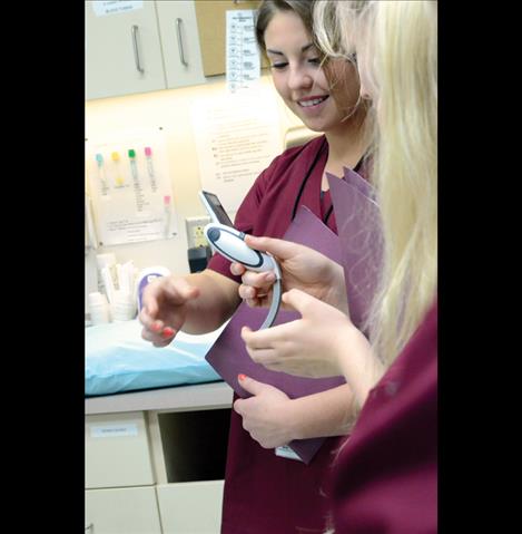 Students examine equipment in the emergency room.