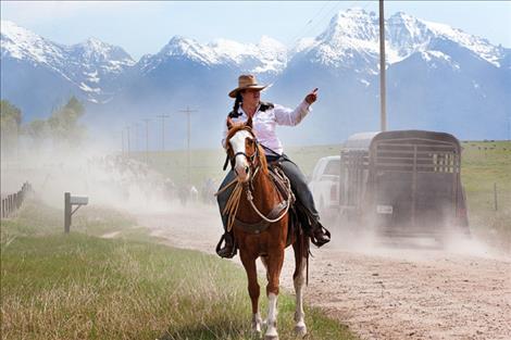 A rider brings up the rear and stops to direct traffic.